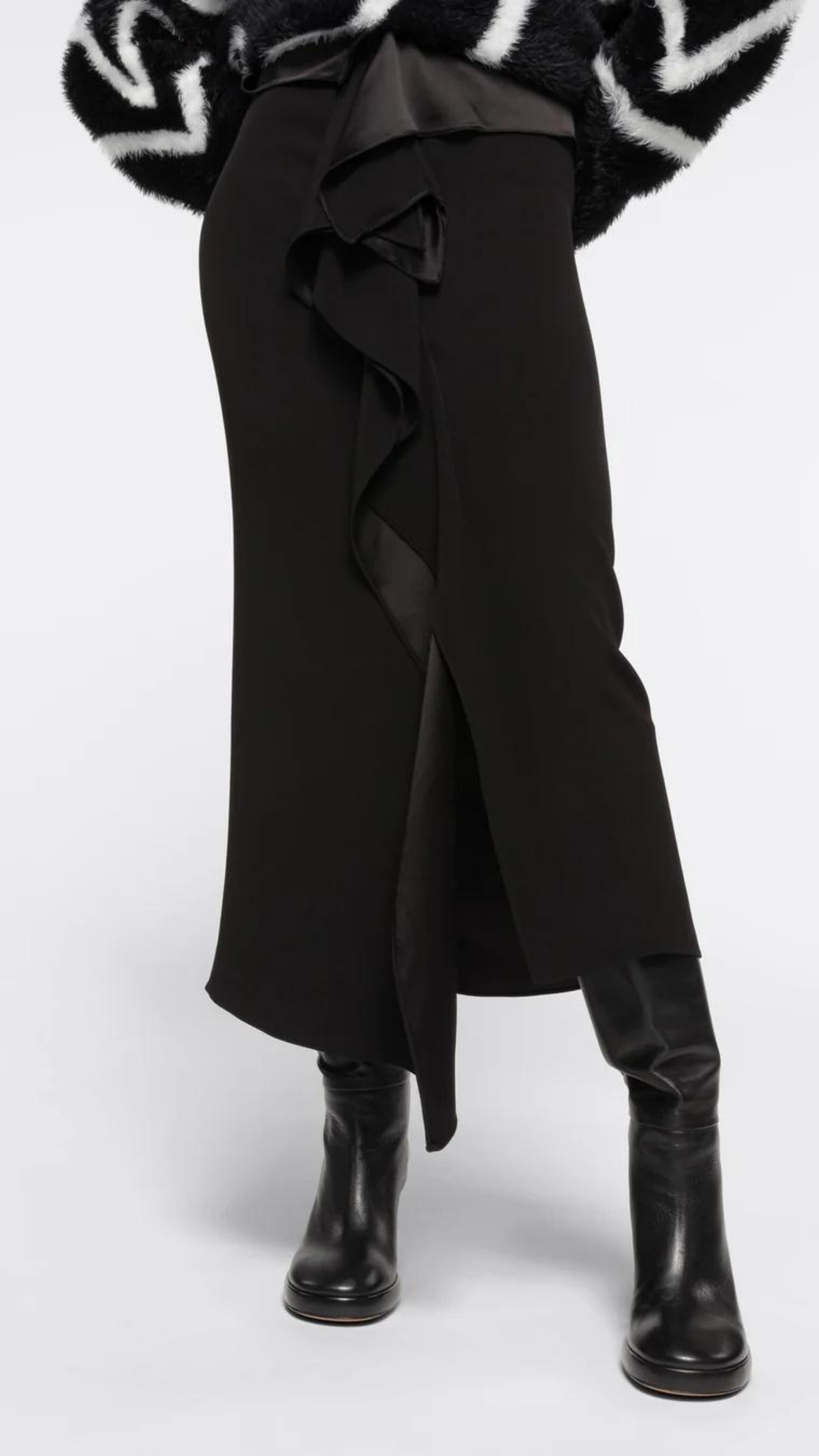 AZ Factory Colville Molly Molloy Lucinda Chambers, Ruffled Crepe Skirt in Black A sleek midi length skirt crafted from a mix of crepe and satin, complemented by a fold-over belt and delicate ruffling along the front panel. Shown from the front view on model.