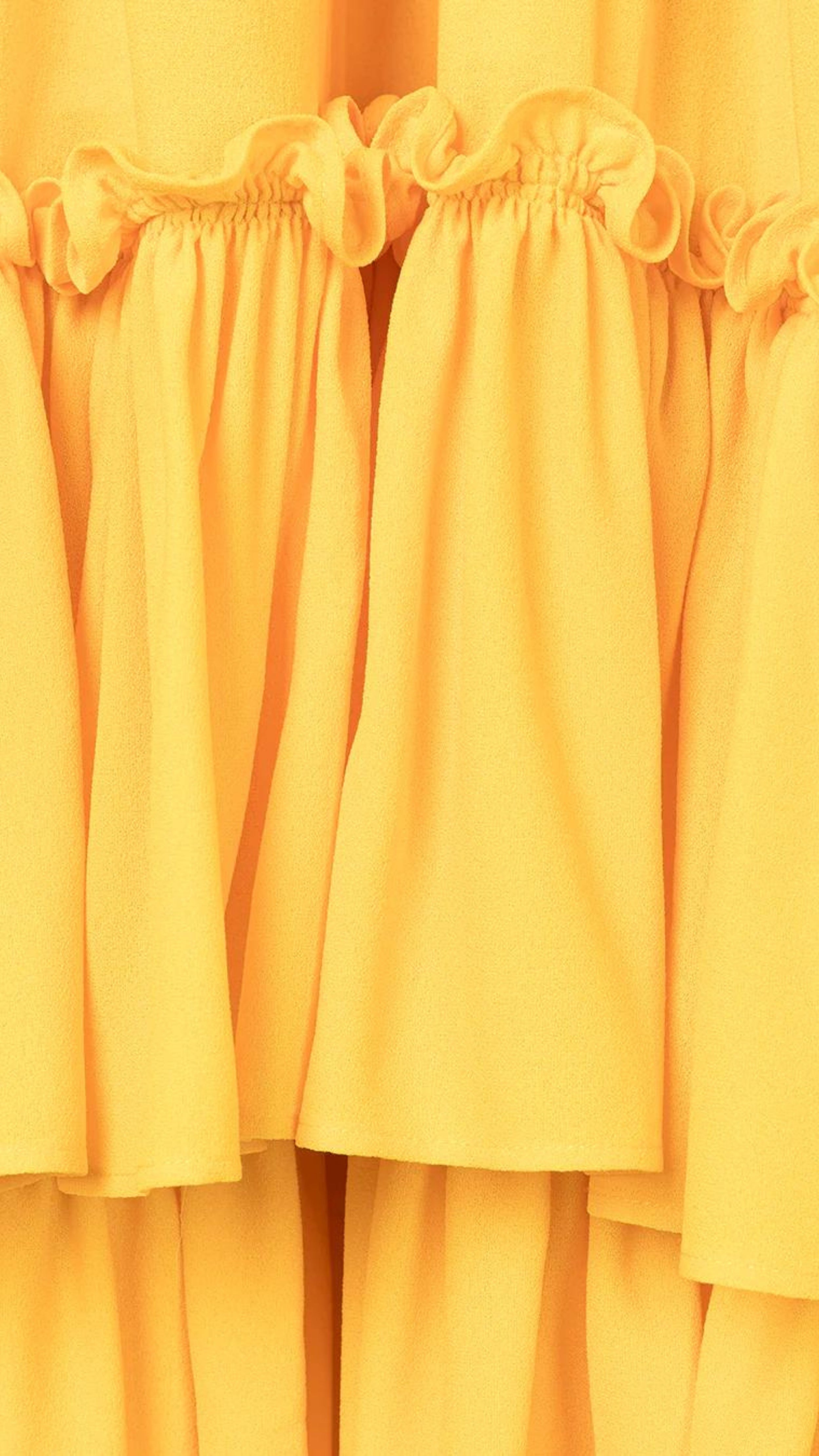 Az Factory Lutz Huelle Marilyn Dress. Bright yellow summer dress in trapeze style. With a v neck and volumnous a-line body and ruffled bottom. Close up of ruffled details.