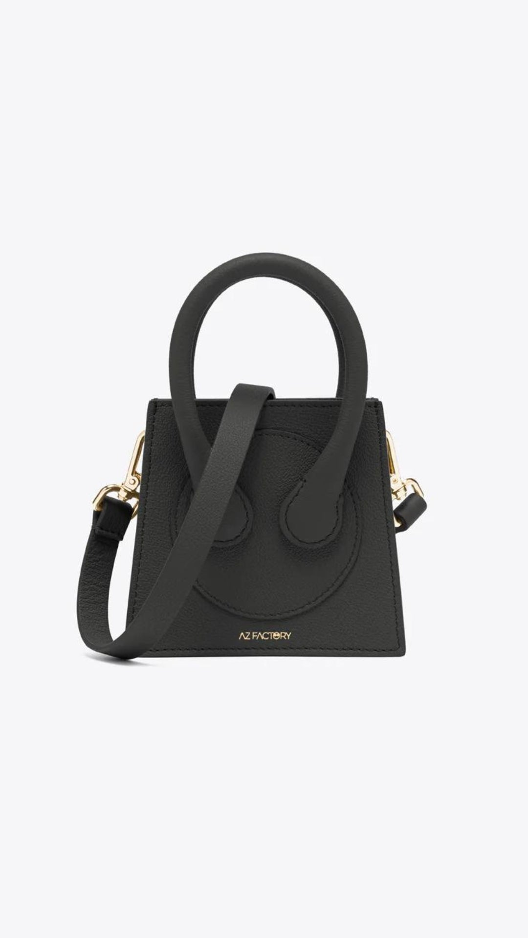 AZ Factory Micro Cake Bag. Handcrafted in Italy with sustainably-sourced overstock calf leather. It is petite in size and has a detachable leather cross-body strap. Inside pockets.  Shown from the front view.