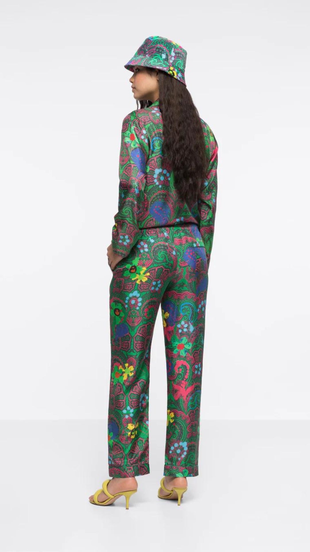 AZ Factory Silk Trousers in Motly Paisley. Pajama style silk pants made in Italy. Featuring a colorful motly paisley print with Alber Ebaz sketches. Shown on model facing back.