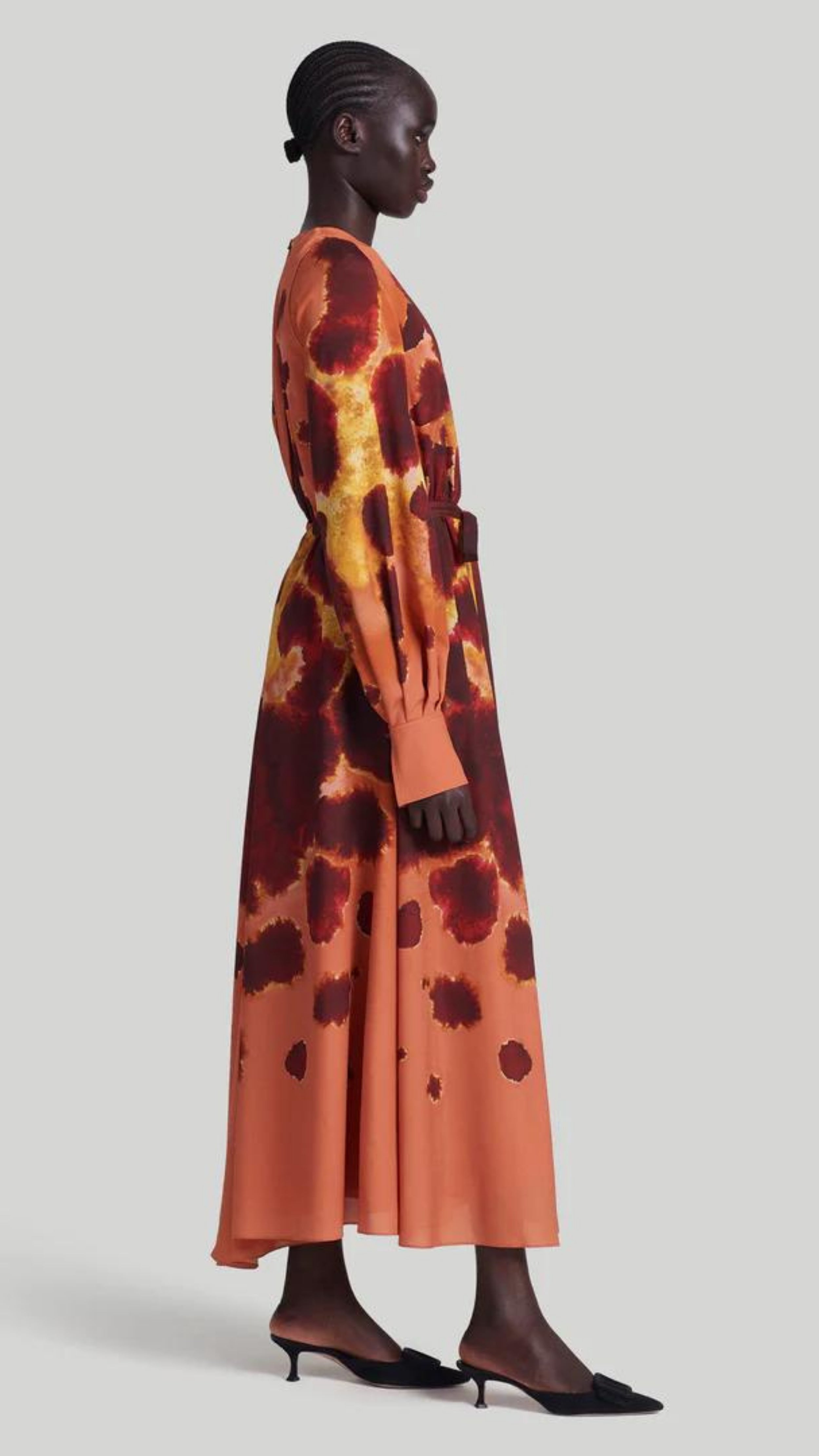 Altuzarra Peirene Dress. The Peirene midi dress has a relaxed silhouette with a tie at the waist. The keyhole neck can be styled closed or open, creating a v-neck look. Made in beautiful peach, cranberry, and yellow dyed pattern. Shown on model facing side