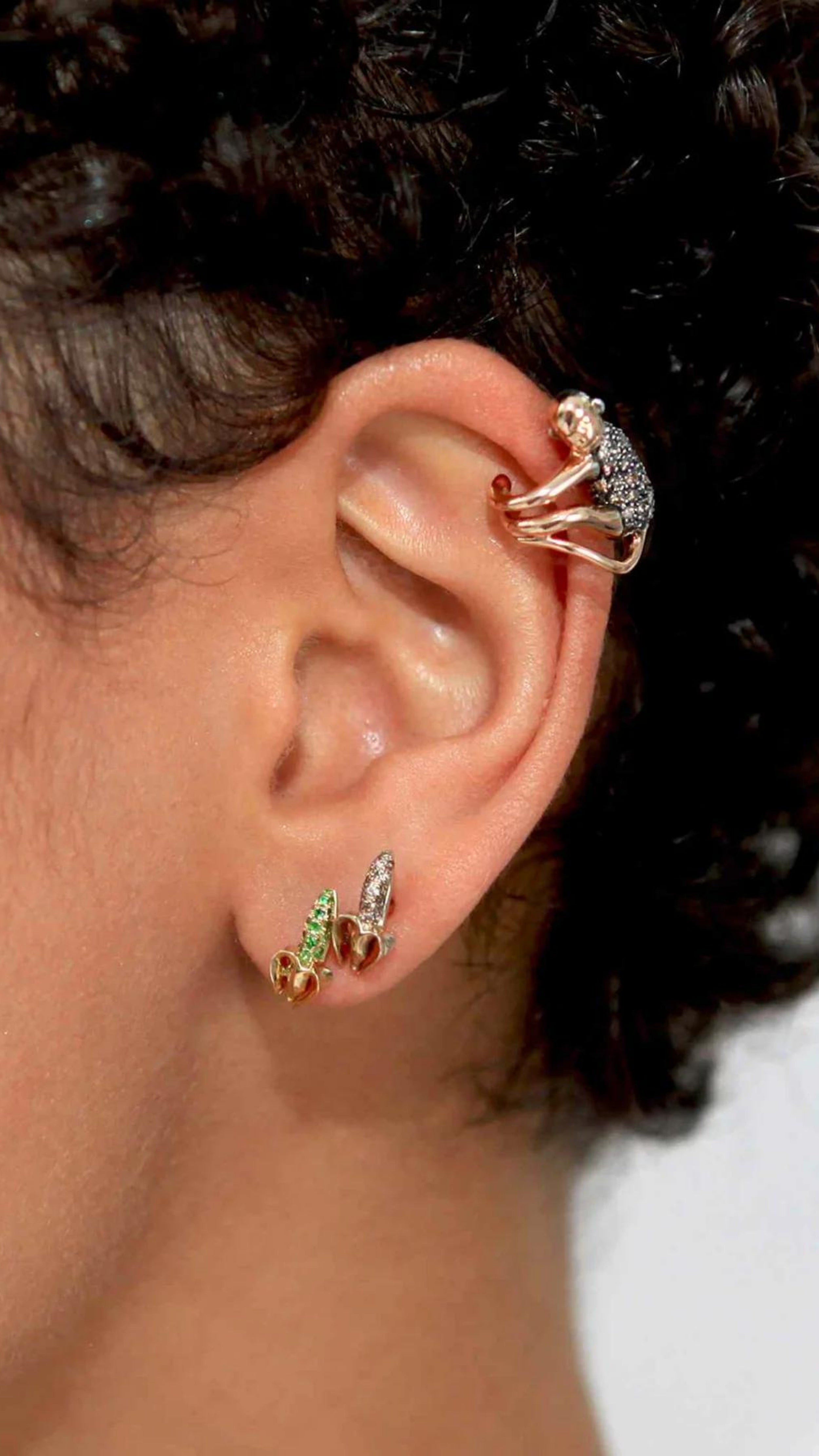 Bibi van der Velden Monkey Mini Banana Stud in Diamond. Single stud earring crafted in the shape of a partially peeled banana. The peel is made from 18K gold and the banana is pave with diamonds. Stud. Photo shows earring being worn by a model.