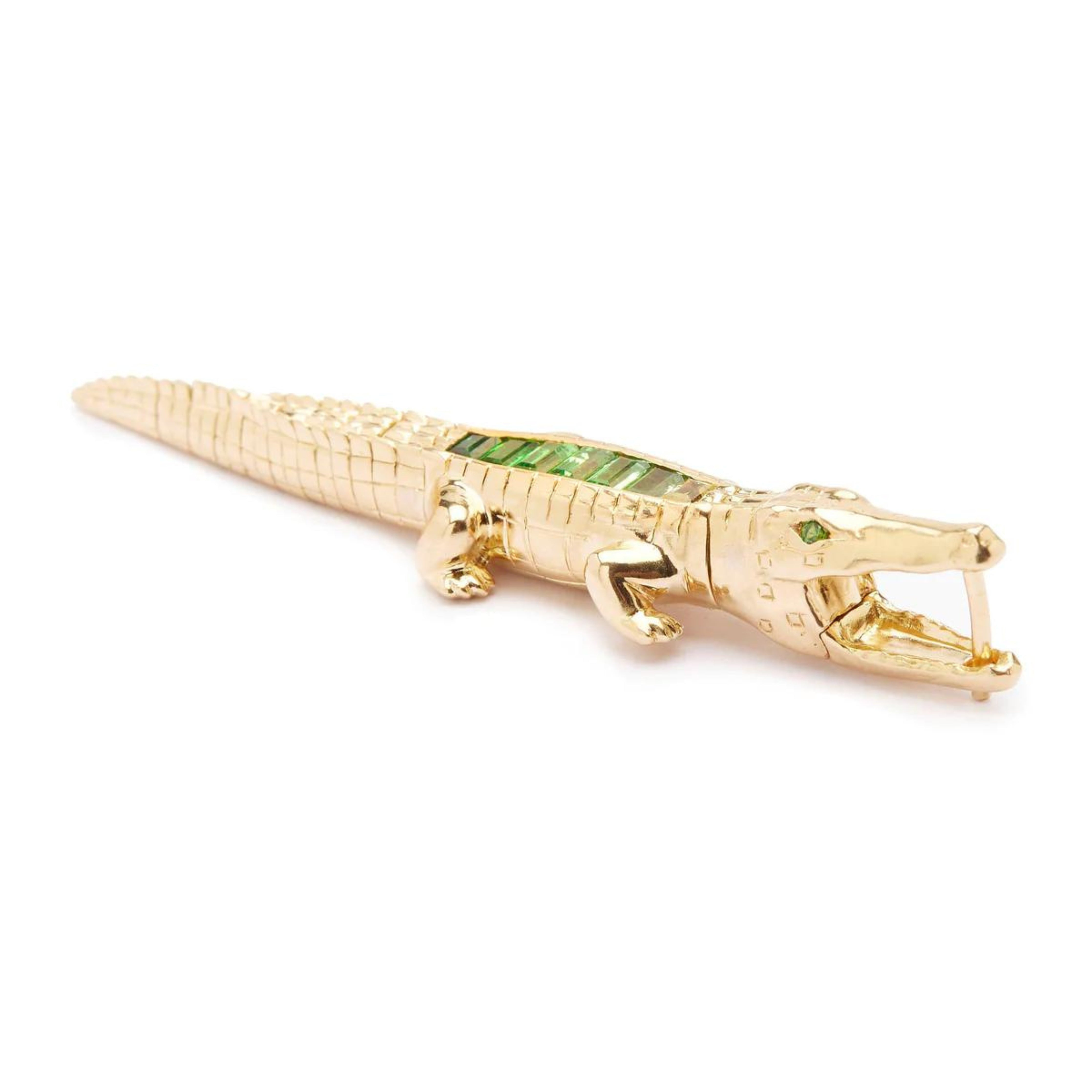 Bibi ven der Velden, Tsavorite Alligator Ear Bite Earring  Crafted in 18K yellow gold and featuring an arrangement of green tsavorites, the intricately carved design replicates an alligator's body. Shown from the side.