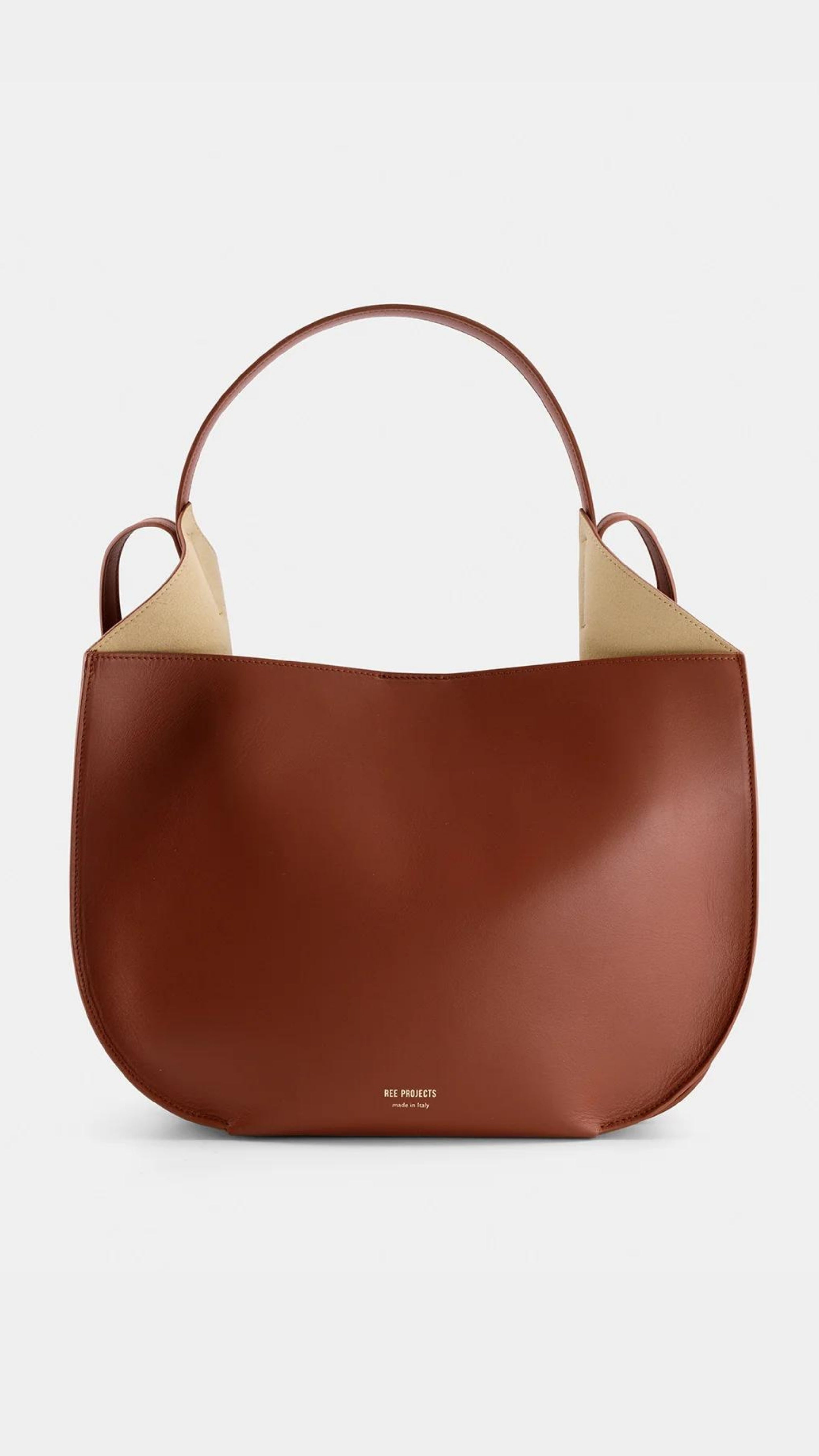 Ree Projects Helen Hobo in Cognac Soft Calf. Medium sized hobo style tote bag made from super soft italian leather. sustainably made in a cognac color. Shown from the front view.