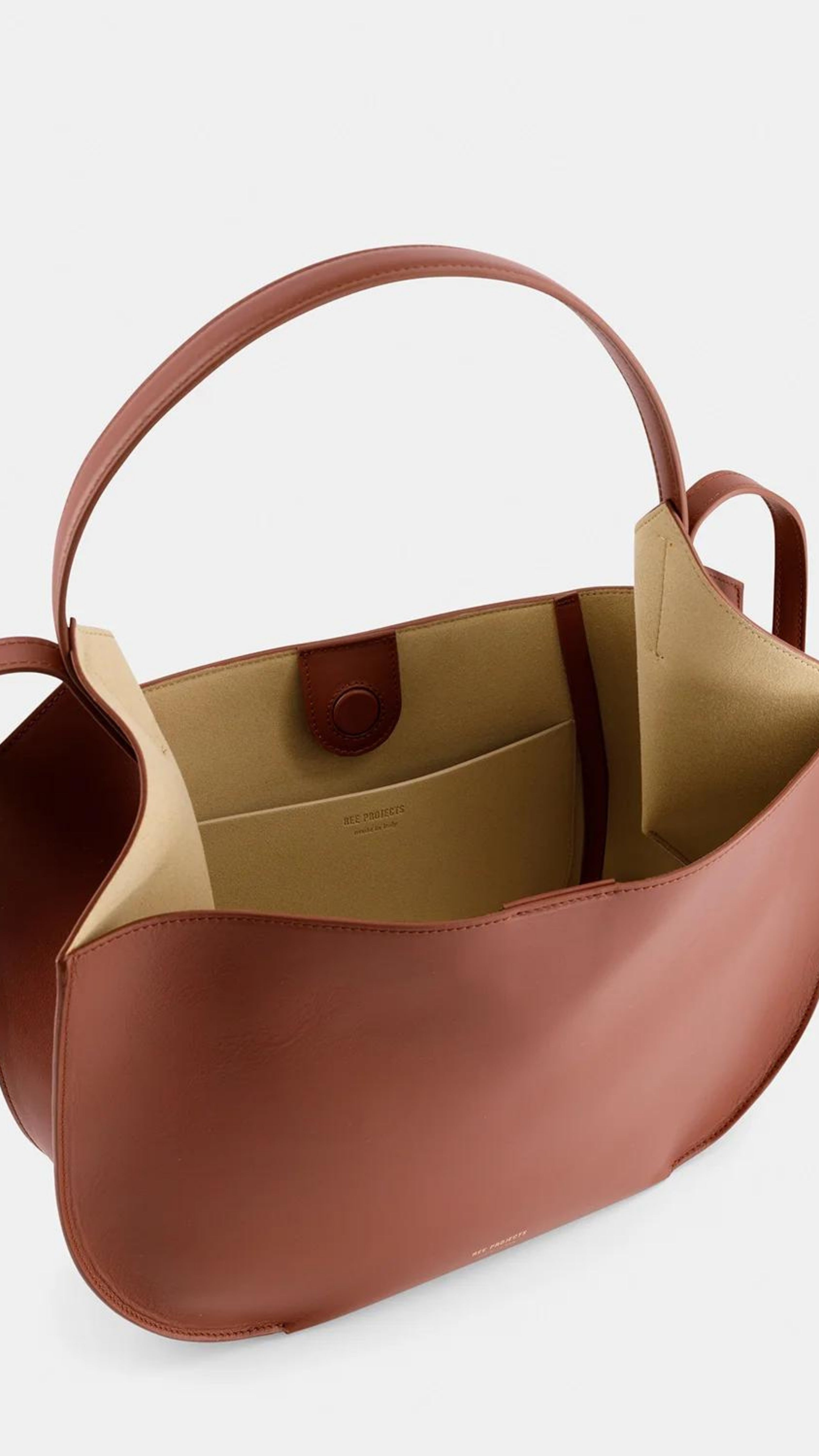 Ree Projects Helen Hobo in Cognac Soft Calf. Medium sized hobo style tote bag made from super soft italian leather. sustainably made in a cognac color. View of the interior.