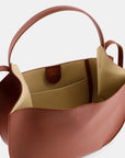 Ree Projects Helen Hobo in Cognac Soft Calf. Medium sized hobo style tote bag made from super soft italian leather. sustainably made in a cognac color. View of the interior.