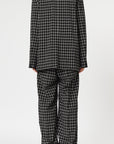 Plan C Checked Black Blazer. Modern suit jacket option in an oversized fit in lightweight wool. Classic black and white check pattern. Shown on model facing to the back.