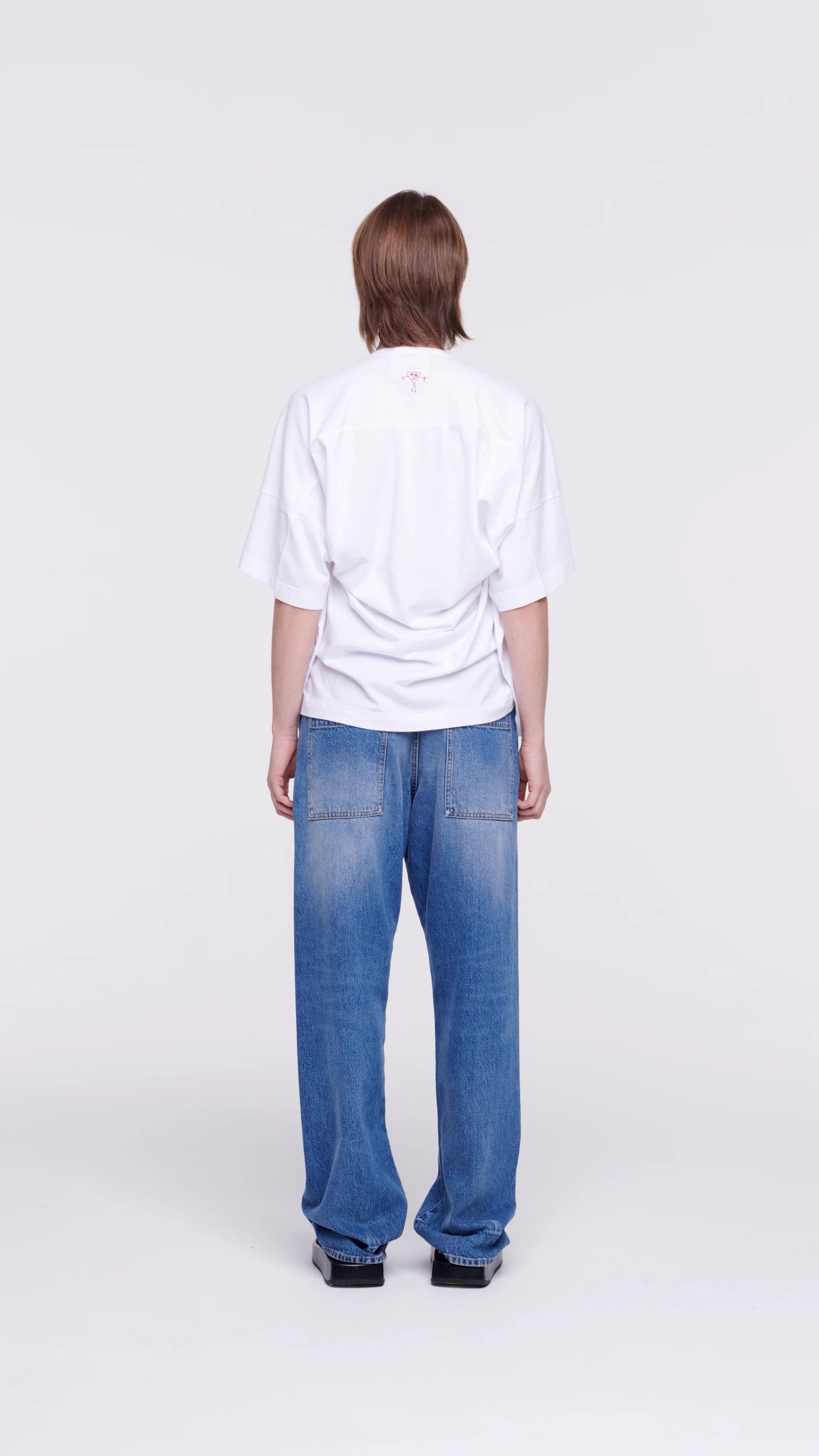 Plan C Draped Back White Cotton Tee 100% cotton, classic white tee with an updated modern draped back. The iconic Bianca patch in bold red adds a discreet accent at the back neckline. Shown on model from the back