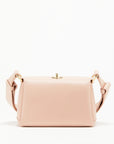 Plan C The Mini Folded Bag in Sand Pink. Luxury handbag crafted in Italy from soft calfskin with an adjustable leather shoulder strap. This purse has a gold-toned turnstile top closure and offers three compartments, one flat zipped and one snap buttoned pocket. Photo shown from the front view.