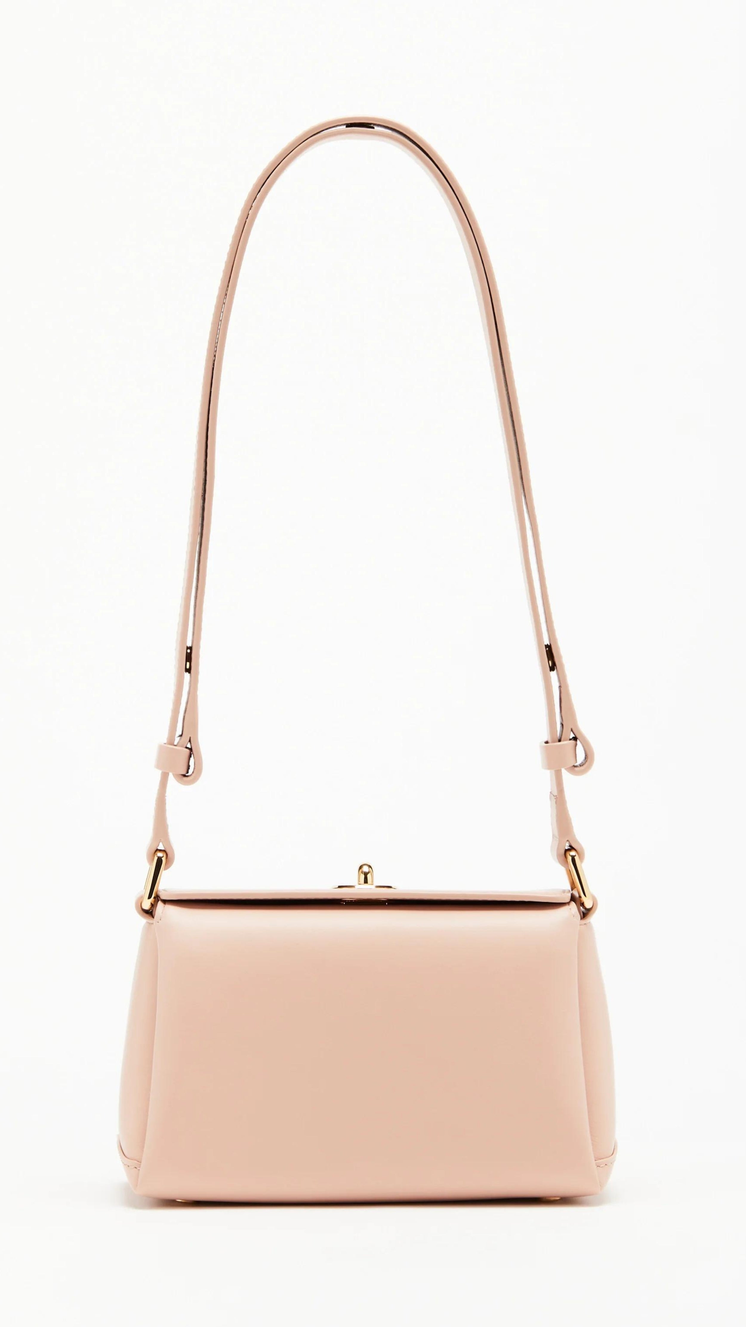Plan C The Mini Folded Bag in Sand Pink. Luxury handbag crafted in Italy from soft calfskin with an adjustable leather shoulder strap. This purse has a gold-toned turnstile top closure and offers three compartments, one flat zipped and one snap buttoned pocket. Photo shown from the front view with the adjustable strap.