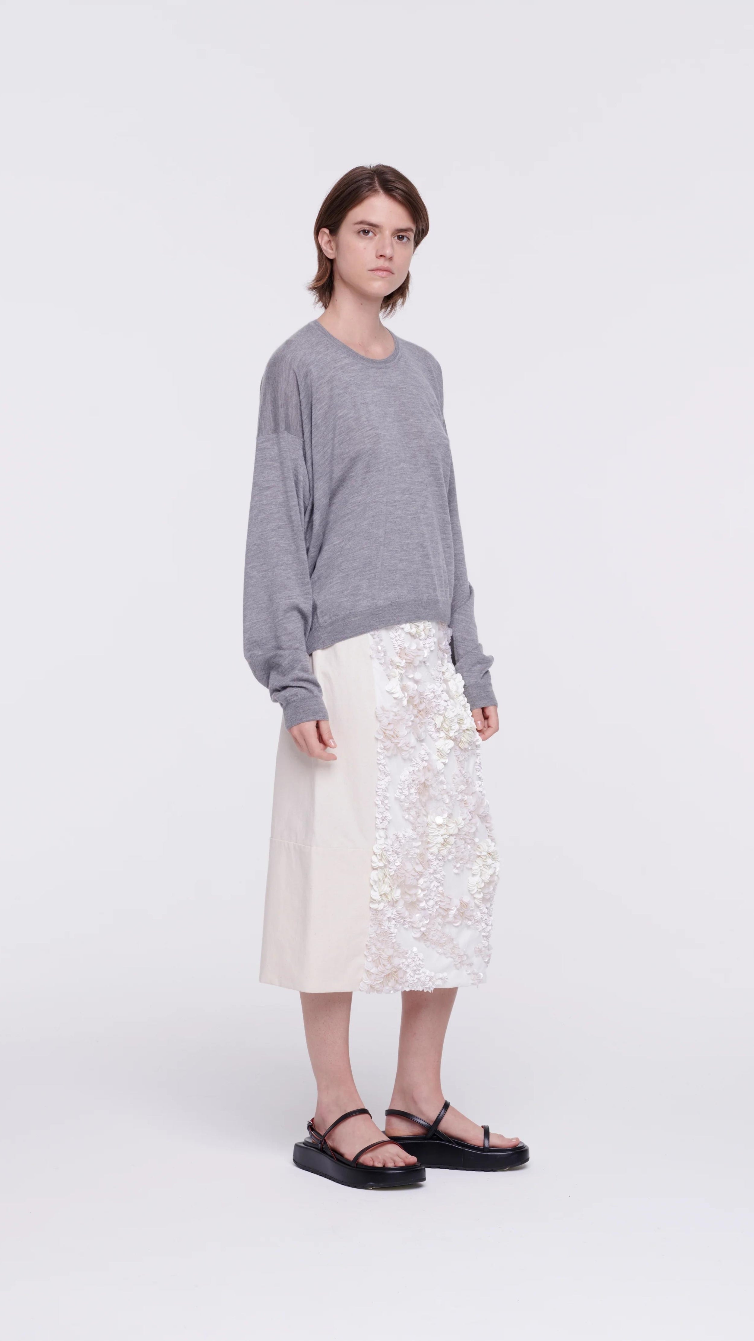 Plan C Panama Sequined Midi Skirt, Cotton panama midi skirt crafted in Italy with front panel of white sequins. This skirt has a contrasting black elastic waistband. The skirt falls to knee length.  Shown on model facing front and to the side