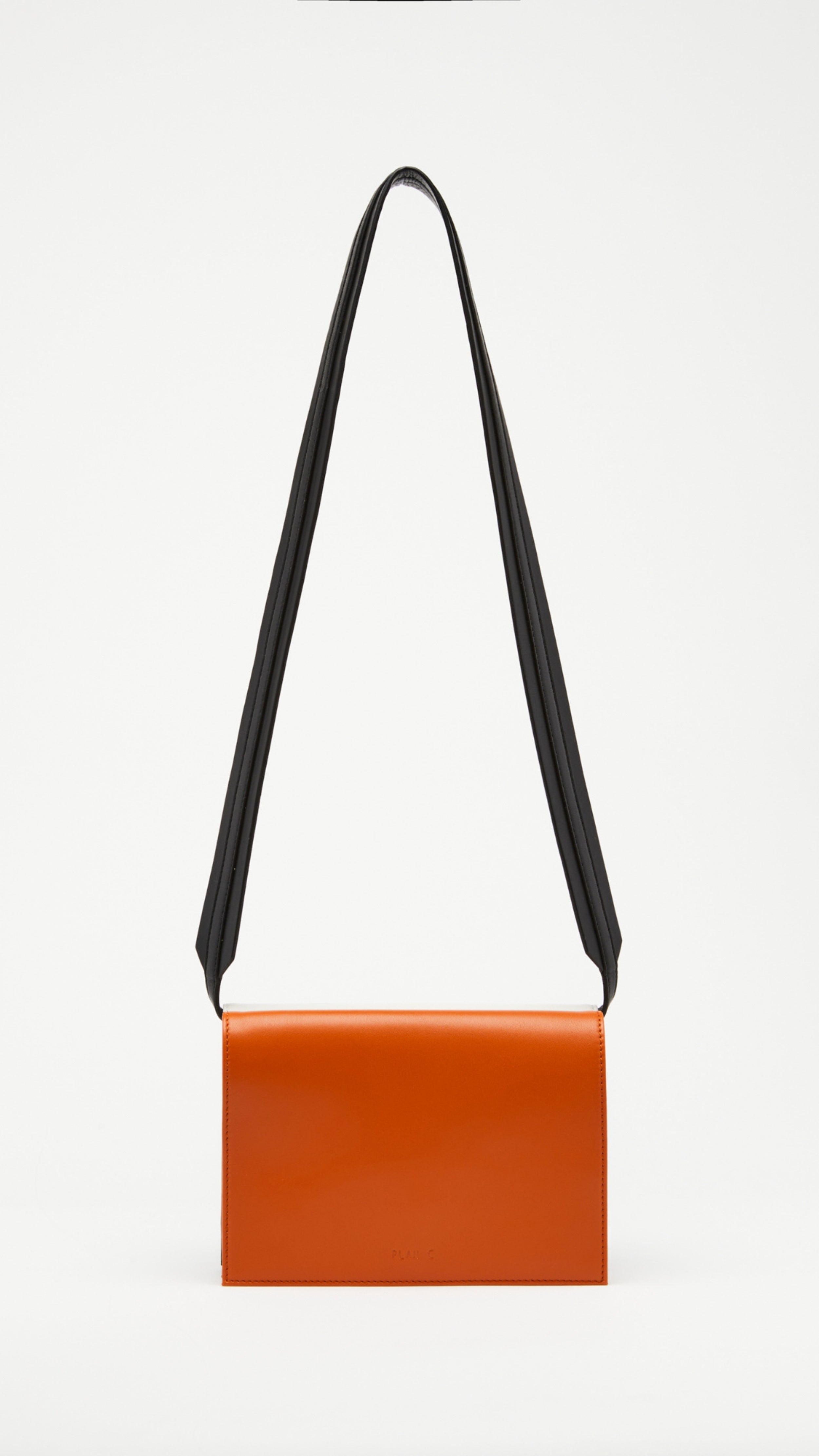 Plan C Tri Color Leather Crossbody Bag. Crafted from fine italian leather in black, white and camel. It has an adjustable black strap. Product shown from back side.