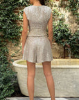 Rochas Paris Fashion High-Waisted Sparkle Shorts in silver sequins. High waisted with a wide leg that lands just above the knee. Shown on model facing back.