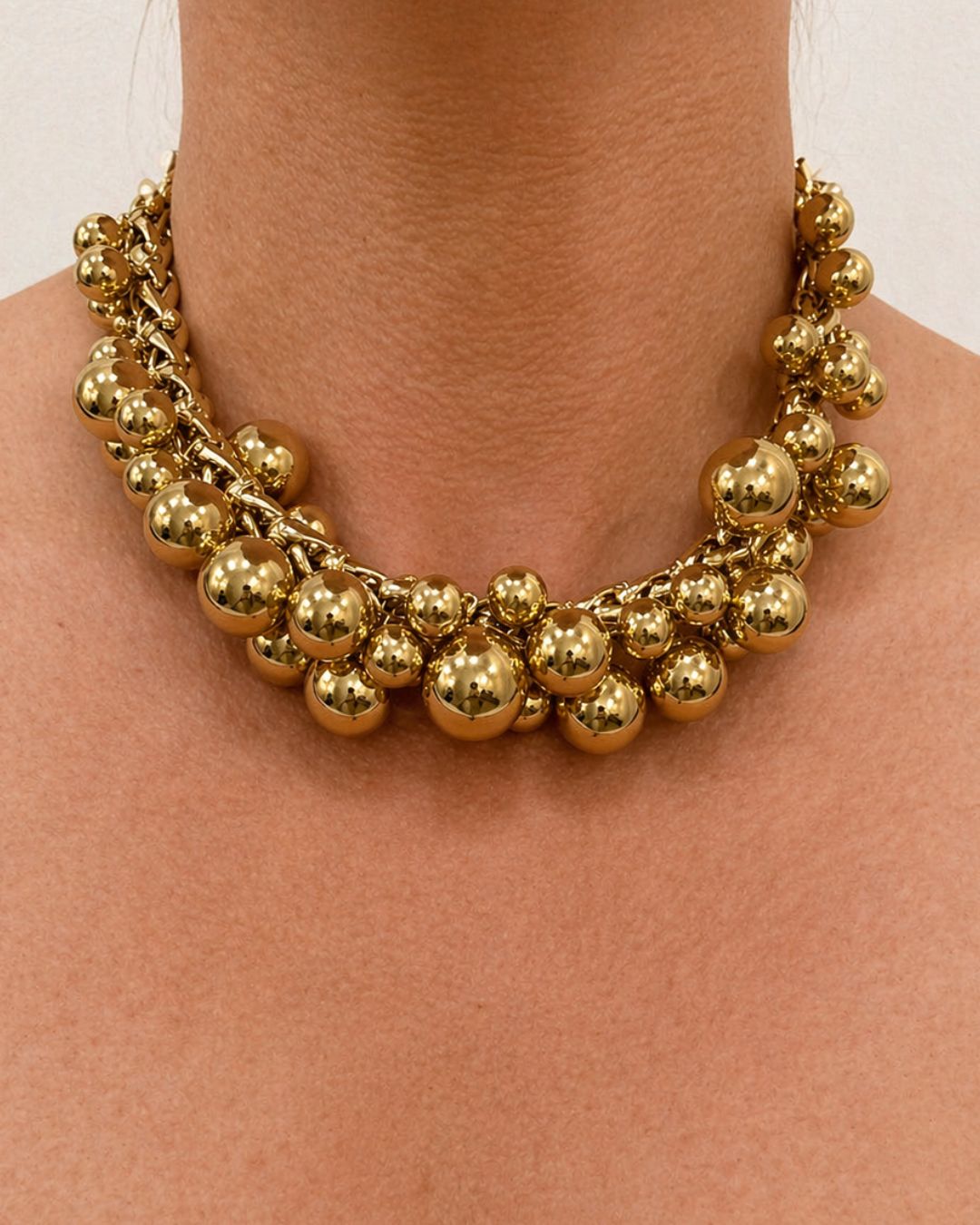 Françoise x Gas Bijoux Stellar Necklace in gold worn on neck, showing full sphere cluster collar effect