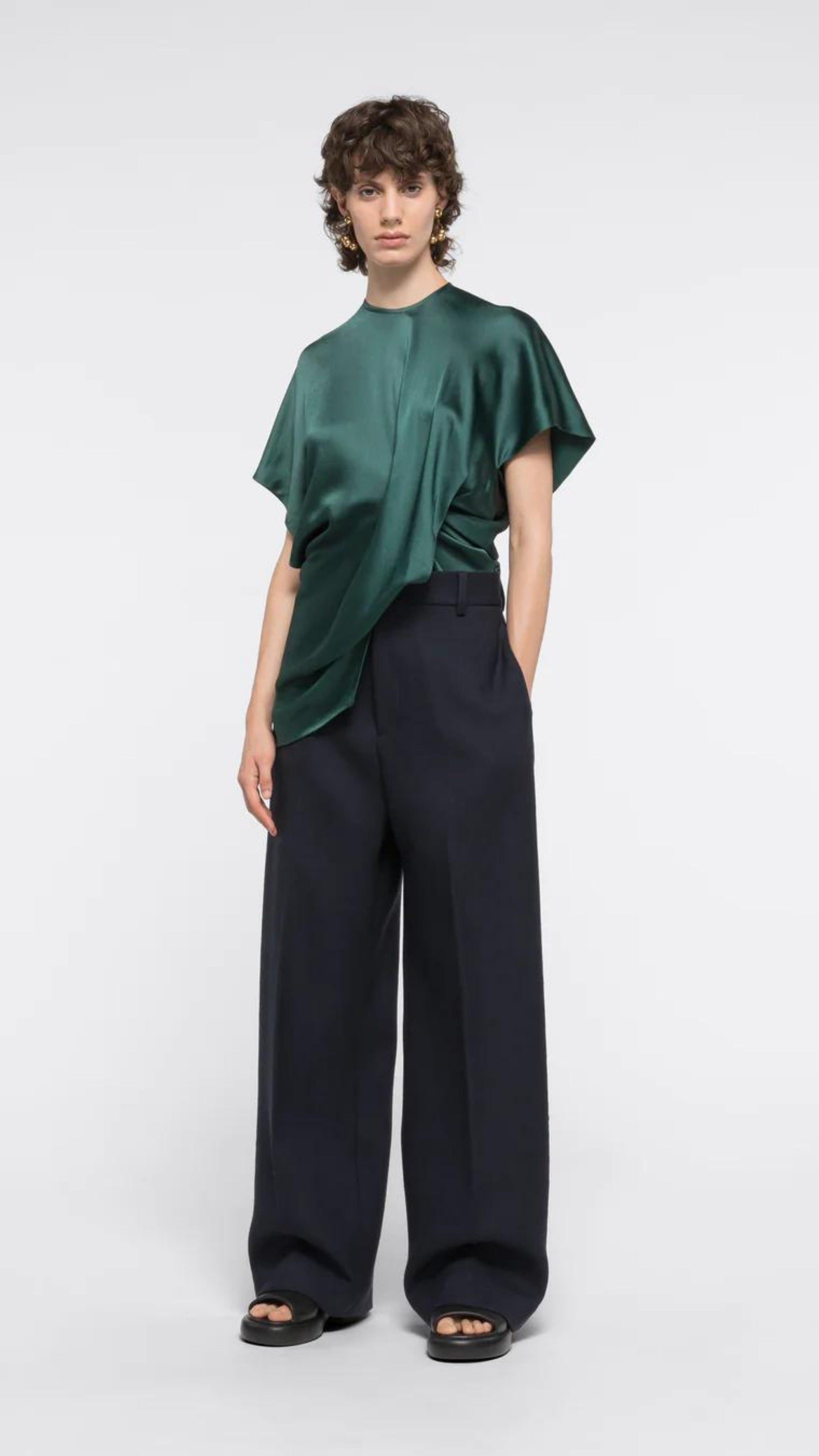 AZ Factory Colville Molly Molloy Lucinda Chambers, Asymmetric Satin Tee Shirt. Elegantly draped in forest green satin material in a classic tee shirt shape. Shown on model facing forward.
