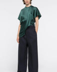 AZ Factory Colville Molly Molloy Lucinda Chambers, Asymmetric Satin Tee Shirt. Elegantly draped in forest green satin material in a classic tee shirt shape. Shown on model facing forward.