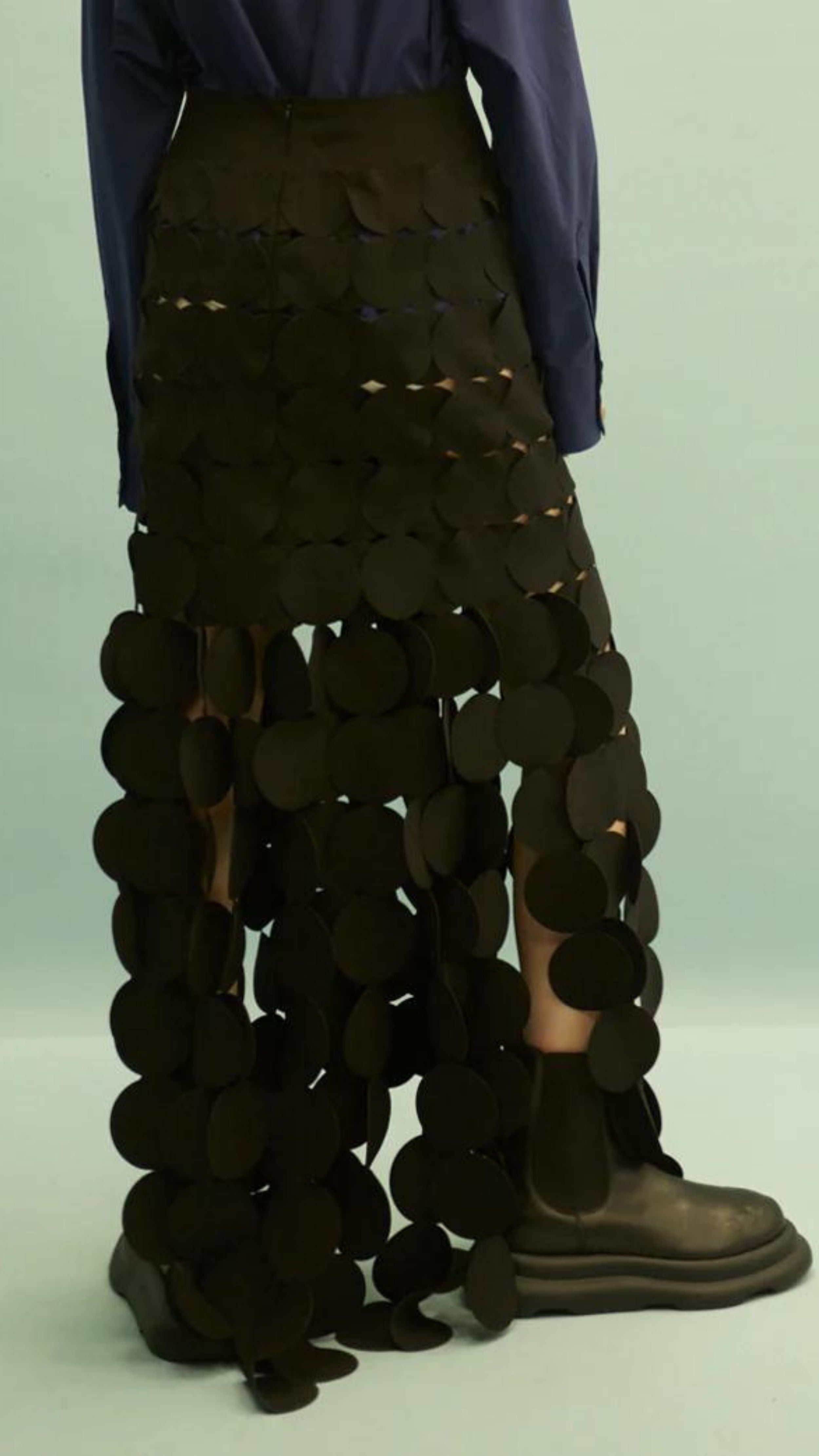 AWAKE Mode Laser Cut Multi Circle Double Layer Skirt. Icon AWAKE Mode circle skirt with a double layer to cover the right areas. With an elastic waist and the circle layers midi to maxi length. Shown on a model close up facing back