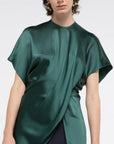 AZ Factory Colville Molly Molloy Lucinda Chambers, Asymmetric Satin Tee Shirt. Elegantly draped in forest green satin material in a classic tee shirt shape. Shown on model facing forward and close up.