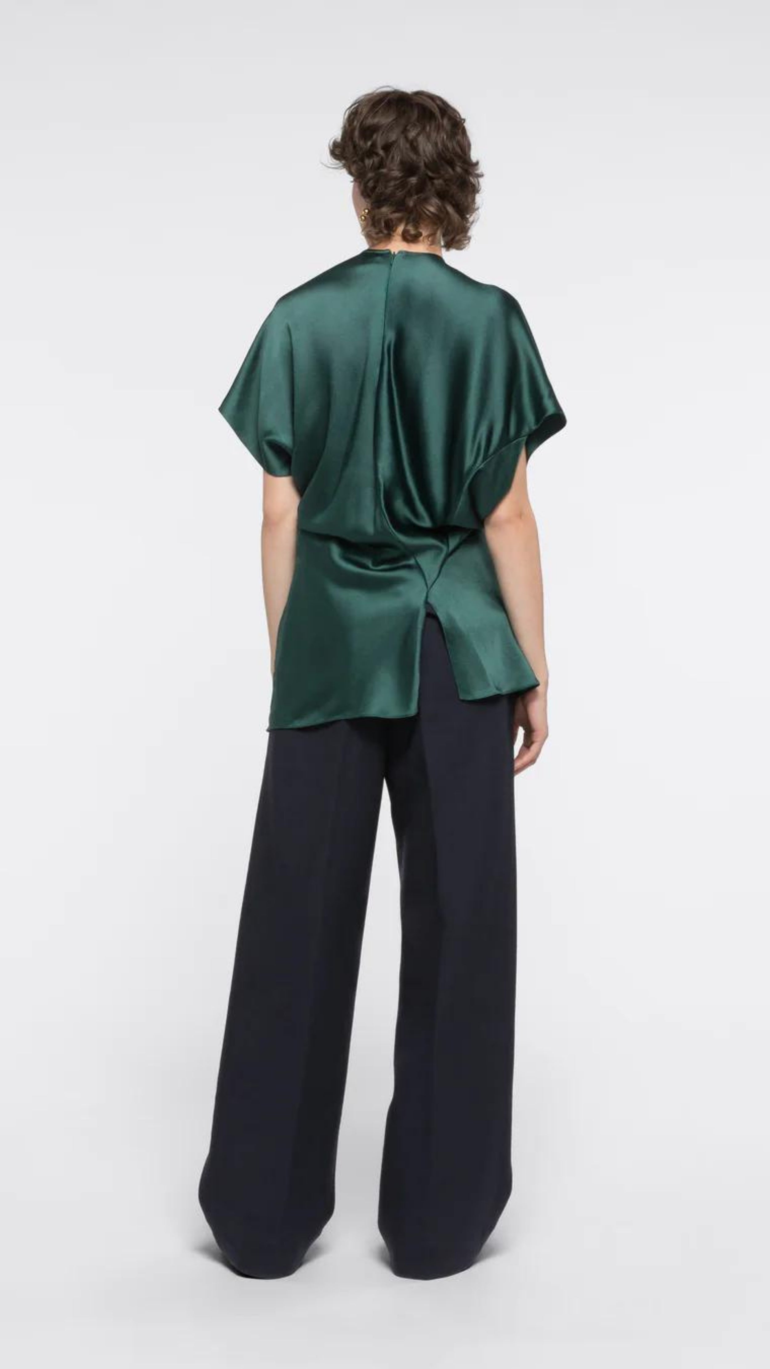AZ Factory Colville Molly Molloy Lucinda Chambers, Asymmetric Satin Tee Shirt. Elegantly draped in forest green satin material in a classic tee shirt shape. Shown on model facing to the back.