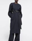 AZ Factory Colville Molly Molloy Lucinda Chambers, Draped Wool Coat in Navy. Wrap around wool coat made in Italy in navy blue. It has an ecru lining and can be worn open or belted for a more fitted style. Shown on model from the front.
