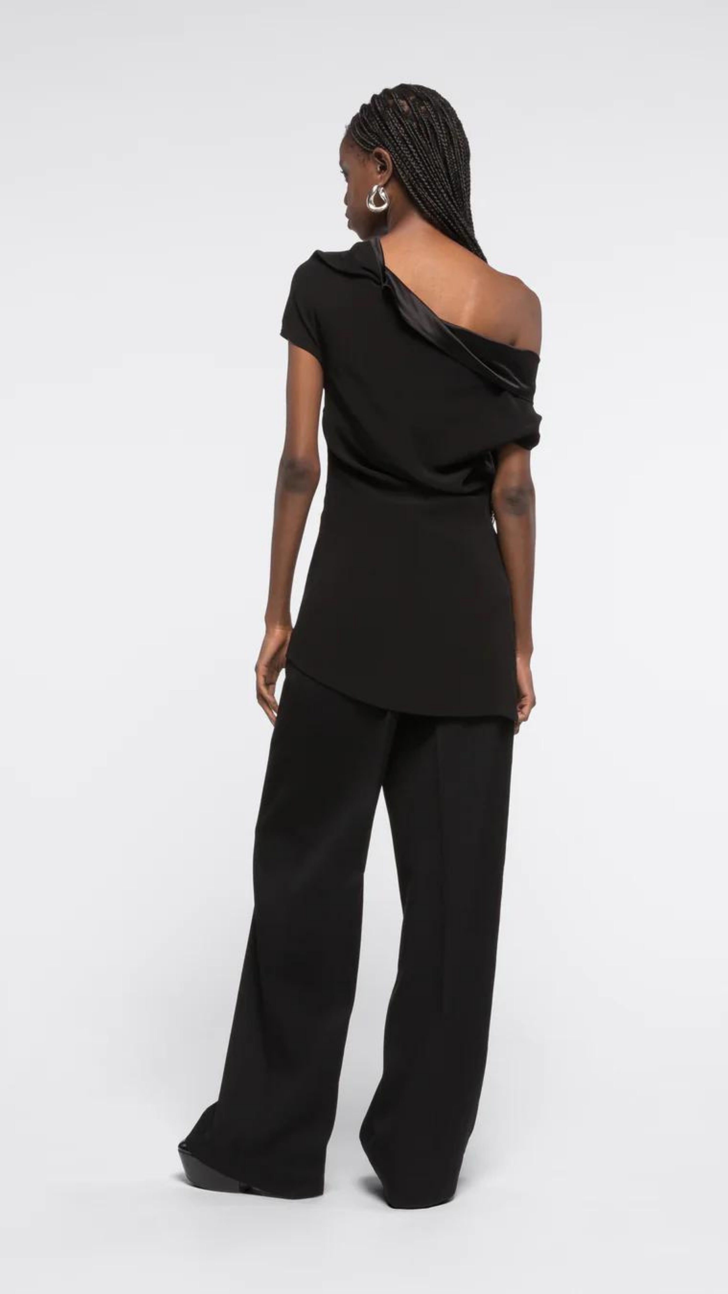 AZ Factory Colville Molly Molloy Lucinda Chambers, Draped Satin Top. Draped satin top with matte and shine satine fabric. Asymmetrical across the top to provide an off the shoulder style on one side. Shown on model from the back.