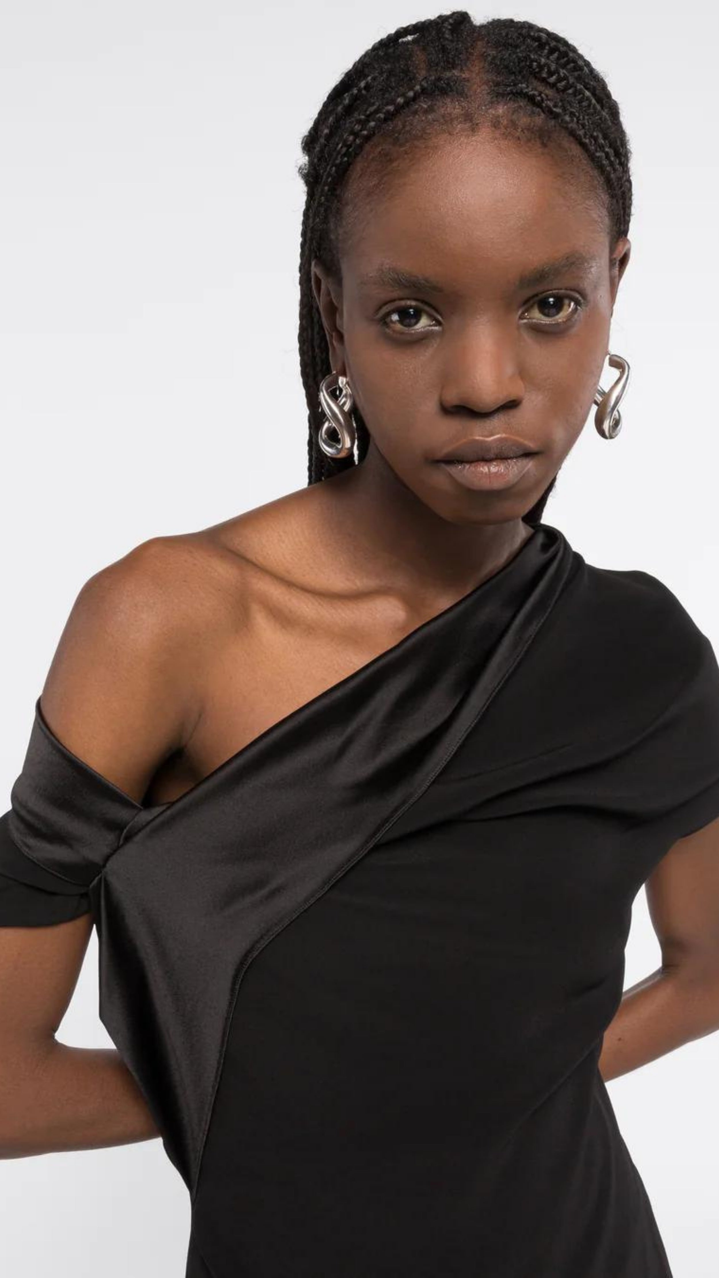 AZ Factory Colville Molly Molloy Lucinda Chambers, Draped Satin Top. Draped satin top with matte and shine satine fabric. Asymmetrical across the top to provide an off the shoulder style on one side. Shown in model with detail close up of the neckline.