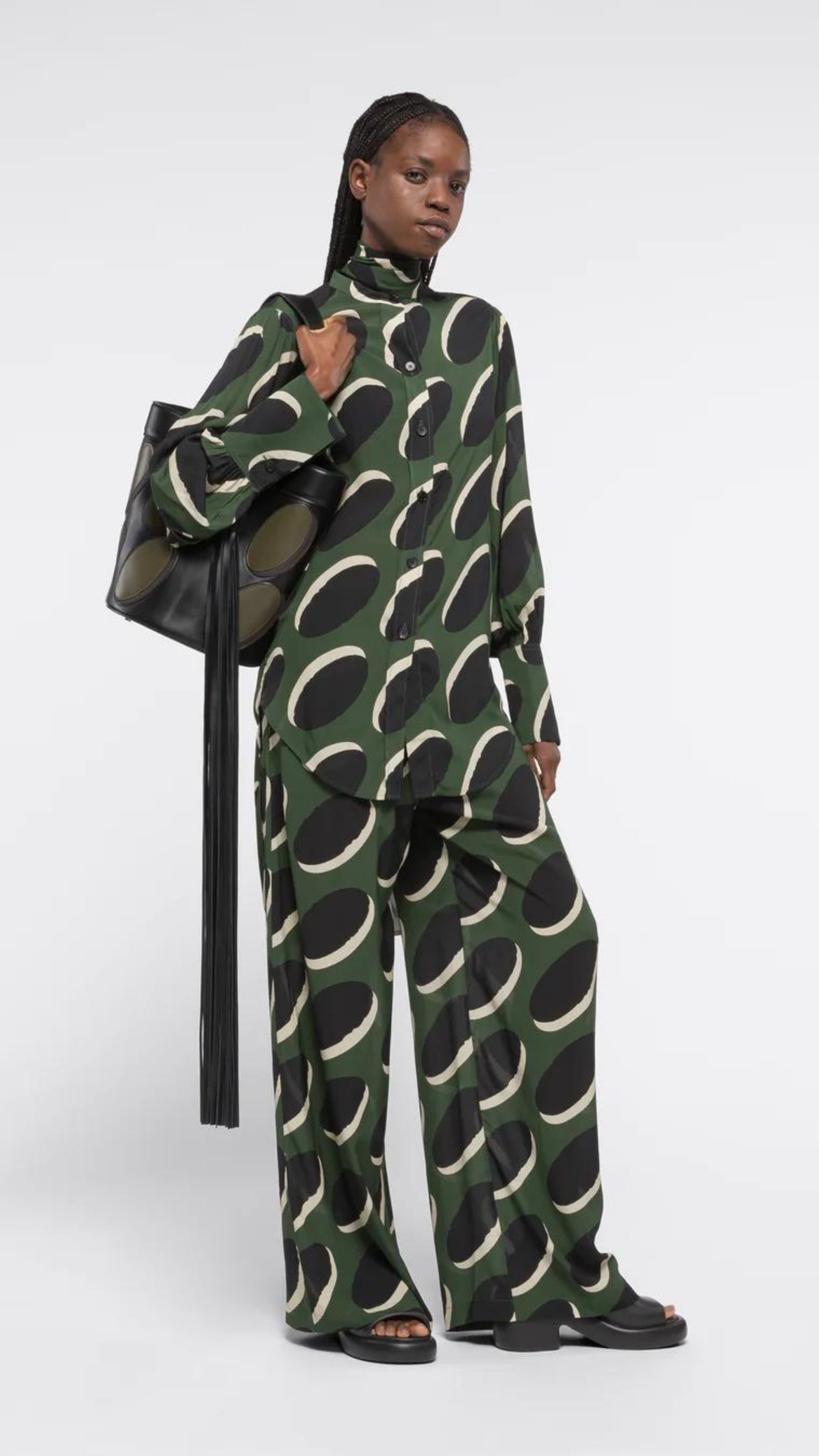 AZ Factory Colville Molly Molloy Lucinda Chambers, Pajama Pants in Khaki Macaroon Pajama loose style silky pants with elastic and drawstring waist band. Crafted in olive green with black and ecru oval pattern. Shown on model facing front.