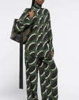 AZ Factory Colville Molly Molloy Lucinda Chambers, Pajama Pants in Khaki Macaroon Pajama loose style silky pants with elastic and drawstring waist band. Crafted in olive green with black and ecru oval pattern. Shown on model facing front.