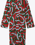 AZ Factory Colville Molly Molloy Lucinda Chambers, Printed Draped Midi Dress. Midi dress with long sleeves and a v cut neckline. It's a rust red with intertwining  rope pattern in green and sky blue. Product photo from the front.