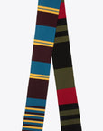 Colville AZ Factory Molly Molloy Lucinda Chambers, Color Block Striped Scarf. Extra long thin scarf with varying stripes in blue, burgundy, yellow, black, and olive green. Photo showing product from above. 