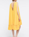 Az Factory Lutz Huelle Marilyn Dress. Bright yellow summer dress in trapeze style. With a v neck and volumnous a-line body and ruffled bottom. Shown on model facing back.