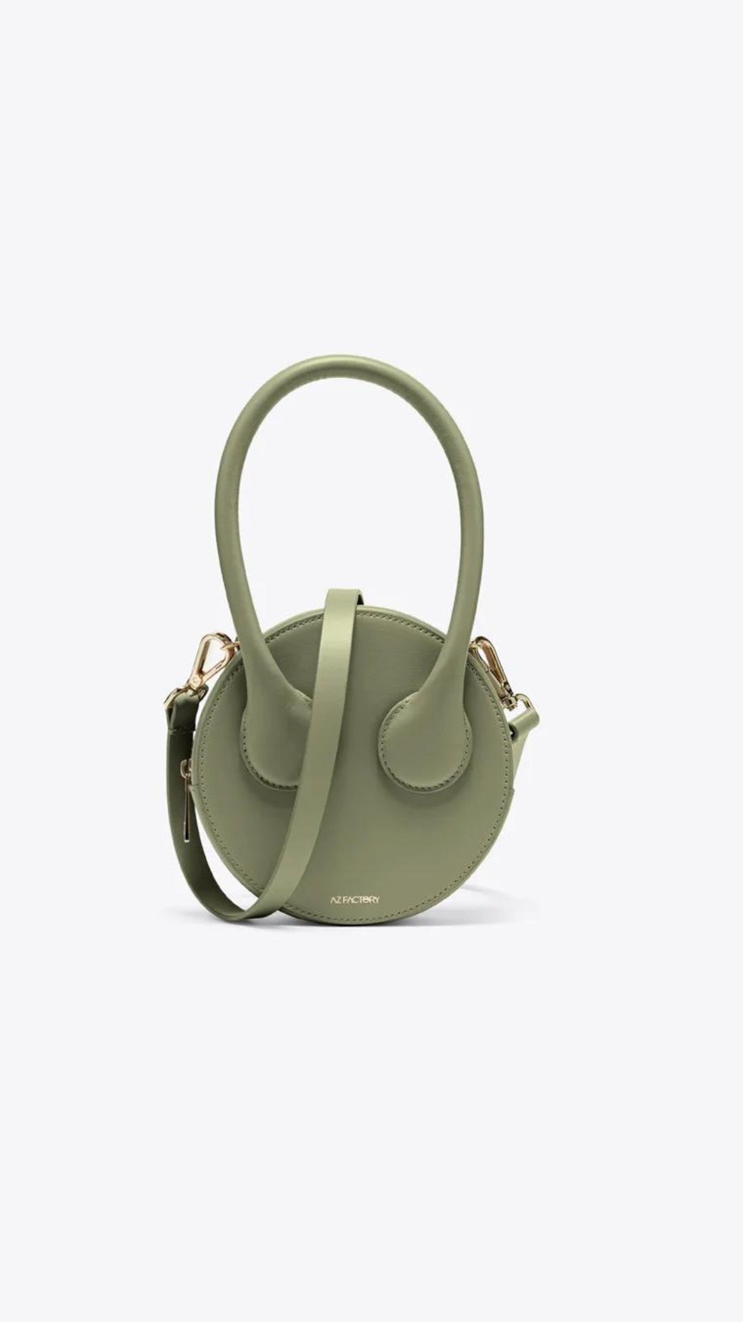 AZ Factory Round Cake Bag in Light Khaki Handcrafted in Italy with sustainable overstock leather, this bag features our AZ Amigo face design, a single extended top handle, and an attachable and adjustable leather cross-body strap. Complete with a zip closure and back pocket. Front view.