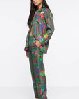 AZ Factory Silk Trousers in Motly Paisley. Pajama style silk pants made in Italy. Featuring a colorful motly paisley print with Alber Ebaz sketches. Shown on model facing side.