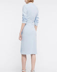 AZ Factory Lutz Huelle, Ella Dress. Crafted with a crepe texture in sky blue hue. V neck and draped, off center gathered front. Half length ruched sleeves  with a midi length skirt. Shown on model facing back