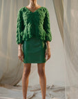 Alejandra Alonso Rojas Leather Mini Skirt with Crochet Seams. Crafted in super soft lamb leather with front and back silk crochet seams in a kelly green. The skirt is shown on the model facing forward.