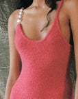 Alejandra Alonso Rojas Machine Knit Dress Pink with Silver Strap. Crafted in the softest camel wool it is a form fitting dress with one thin straps and one silver metallic strap and falls to midi length. It has a slit to just above the knee on one side. Detail photo of the neckline on the model.
