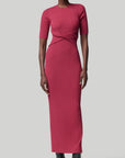 Altruzarra, Argolis Dress. Rose pink colored ribbed knit dress. Body hugging with flattering, slimming from waist detail. It has a rounded collar, half short sleeves and midid length. There are two side slits to the knee. Shown on model facing front. Available at experience 27 in madrid spain.