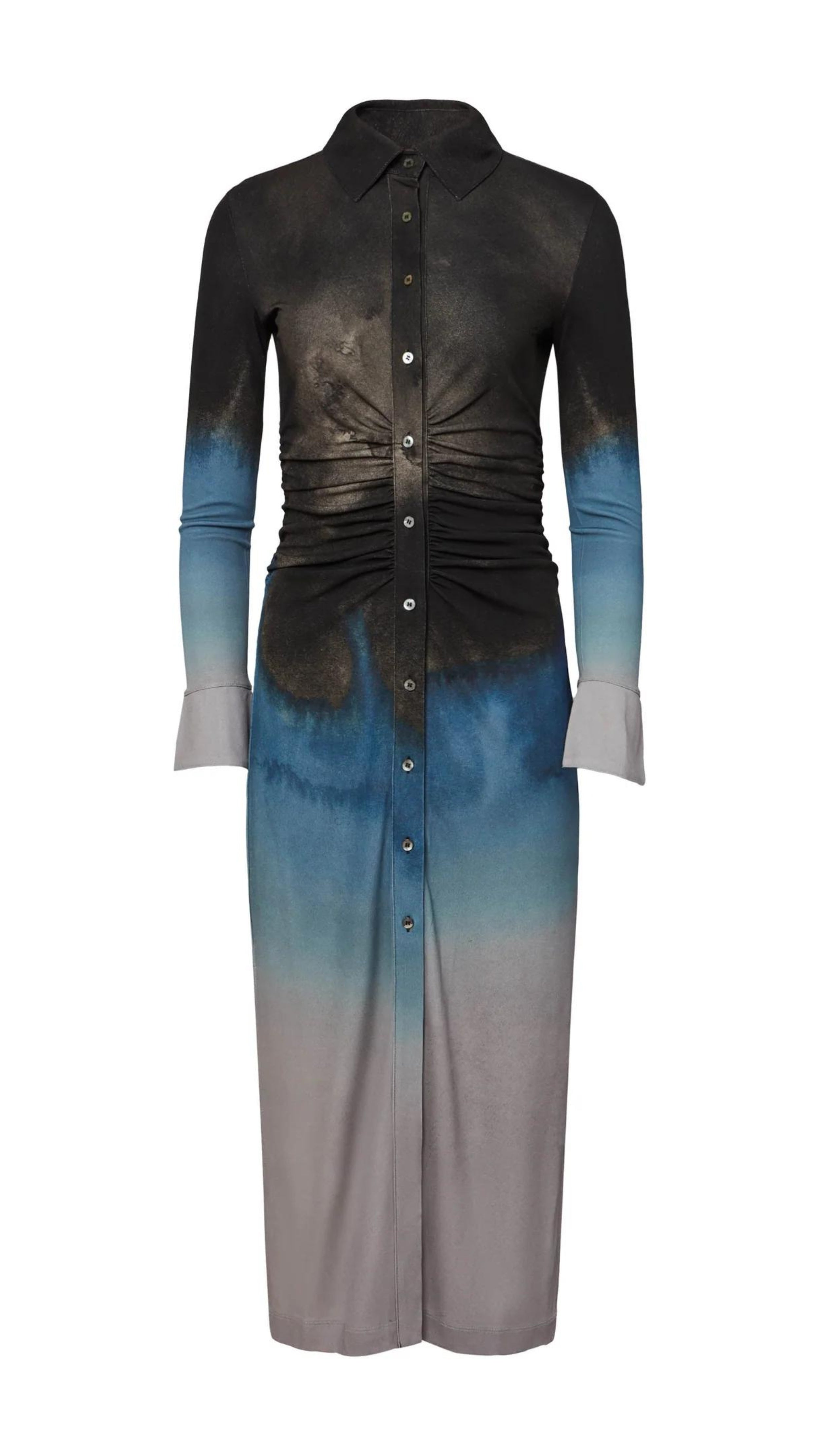 Altuzarra Claudia Dress in Eventide Made from jersey fabric, it is a slim-fitting midi dress featuring ruched detail at the waist, shirt dress buttons up the front, and side slits at the hem. The color is an ombre of deep grey, blue, and pale grey. Product photo facing front.