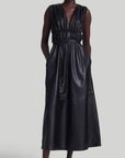 Altuzarra Fiona Dress, made from soft lamb leather. It features a maxi silhouette with a low V-neck, sleeveless, and ruching that folds at the waist with a thin leather belt. Shown on model facing front.