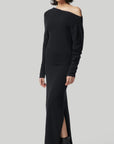 Altuzarra Black Cashmere Kasos Dress. The dress features an oversized off-the-shoulder top, slim long sleeves, an ankle-length skirt with a side slit hem. Off duty ballerina elegance in the style. Photo shows model wearing the dress facing to the side.