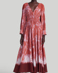 Altuzarra Kathleen Dress The Kathleen Dress is a statement dress using Altuzarra's renowned Shibori dyeing technique in shades of red, cranberry and orange. It has a maxi silhouette, a V-neckline, a ruched waist, long pleated sleeves, and button-fastening cuffs. Shown on model facing front.