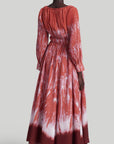 Altuzarra Kathleen Dress The Kathleen Dress is a statement dress using Altuzarra's renowned Shibori dyeing technique in shades of red, cranberry and orange. It has a maxi silhouette, a V-neckline, a ruched waist, long pleated sleeves, and button-fastening cuffs. Shown on model facing back.