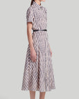 Altuzarra Kiera Dress The 'Kiera' dress is designed with a small point collar, short sleeves and a flattering A-line skirt. It is detailed with a slim leather waist belt and features a black and white stripe pattern and a front breast pocket. Shown on model facing side.