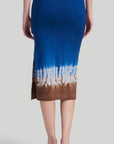 Altuzarra 'Morse' skirt, featuring Altuzarra's iconic Shibori tie-dye technique in brown, white, and blue. Made from 100% Superfine Merino 130's wool, this high-rise pencil silhouette midi length skirt. Shown on model facing back.