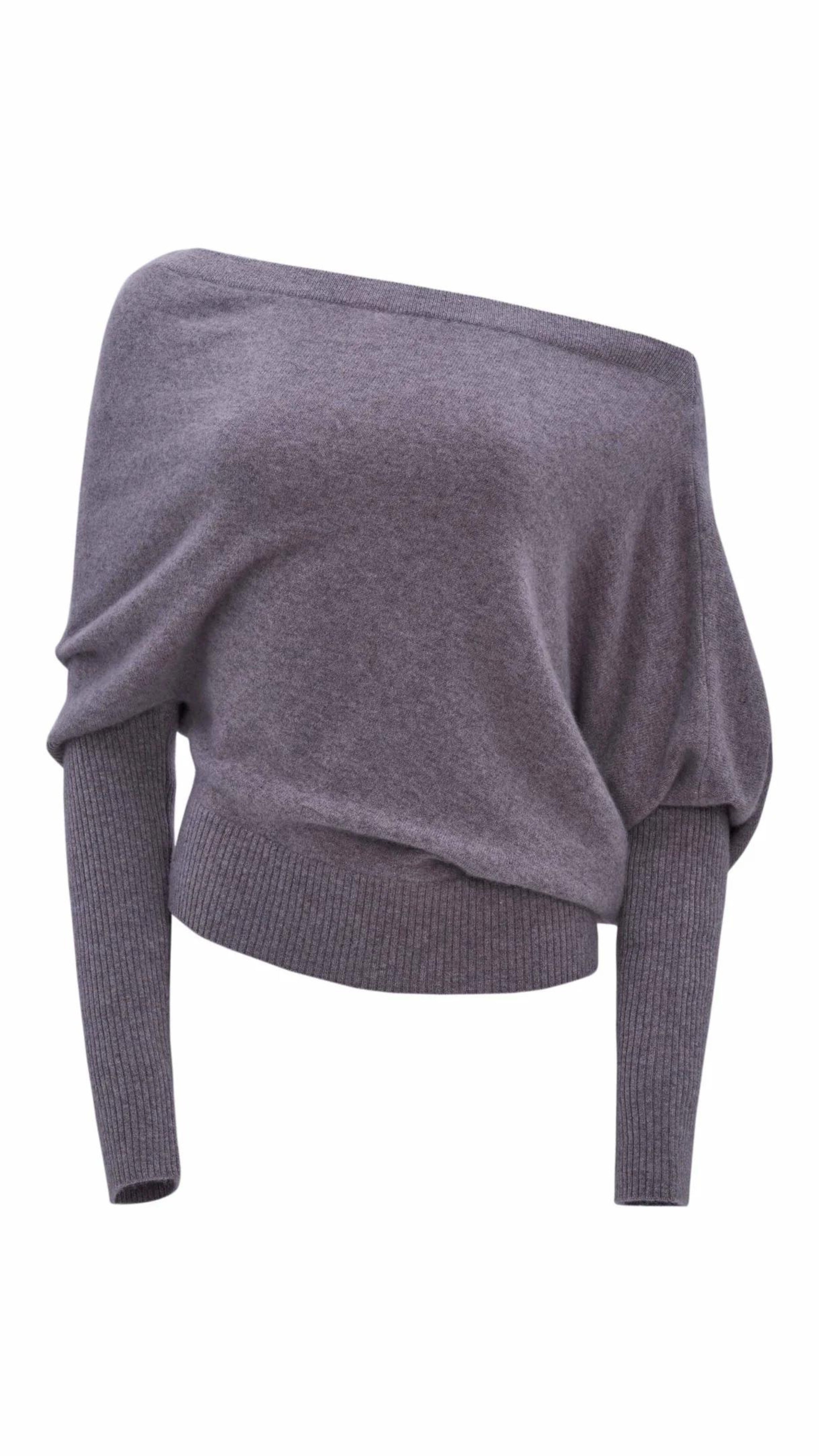 Altuzarra Paxi Cashmere Sweater in Grey. Luxury soft knit jumper in light gray, off the shoulder style. With a fitted waist line and sleeves for an elegantly casual look. Product photo front side.