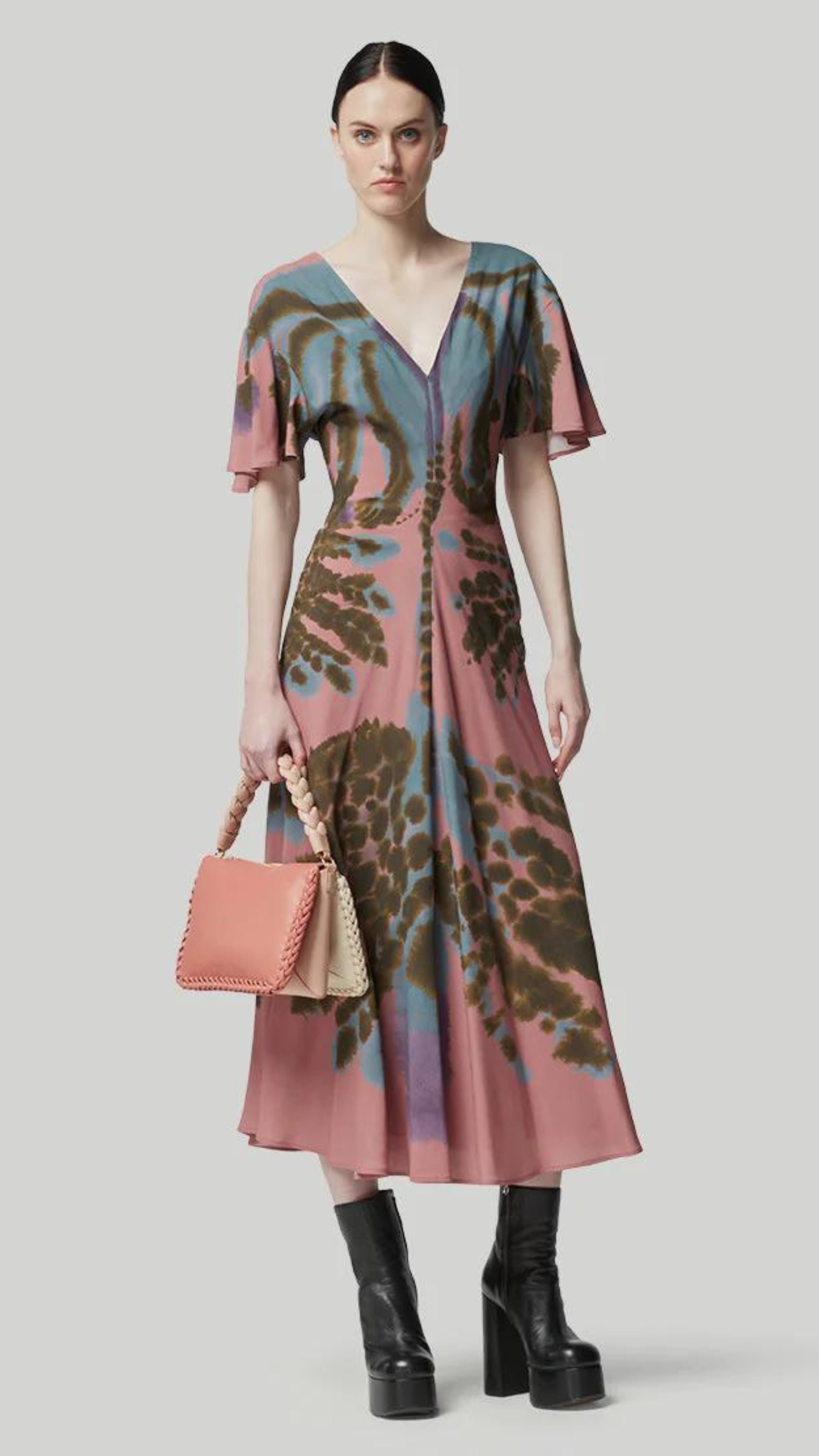 Altuzarra Pelopenese Dress. Rose pink, sky blue and green rorschach pattern midi dress. With a v neckline and soft draping half sleeves. Flowing skirt with waist line rouching. Shown on the model facing foreward.