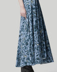 Altuzarra Pythia Skirt in Amsonia Shibori Flower. A midi length, aline style skirt with beautiful twist detail at the waist. Crafted in 100% cotton with a natural ecru color floral print over a light blue background. Shown on model facing side. Available at experience 27 in Madrid spain.