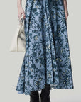 Altuzarra Pythia Skirt in Amsonia Shibori Flower. A midi length, aline style skirt with beautiful twist detail at the waist. Crafted in 100% cotton with a natural ecru color floral print over a light blue background. Shown on model facing front. Available at experience 27 in Madrid spain.