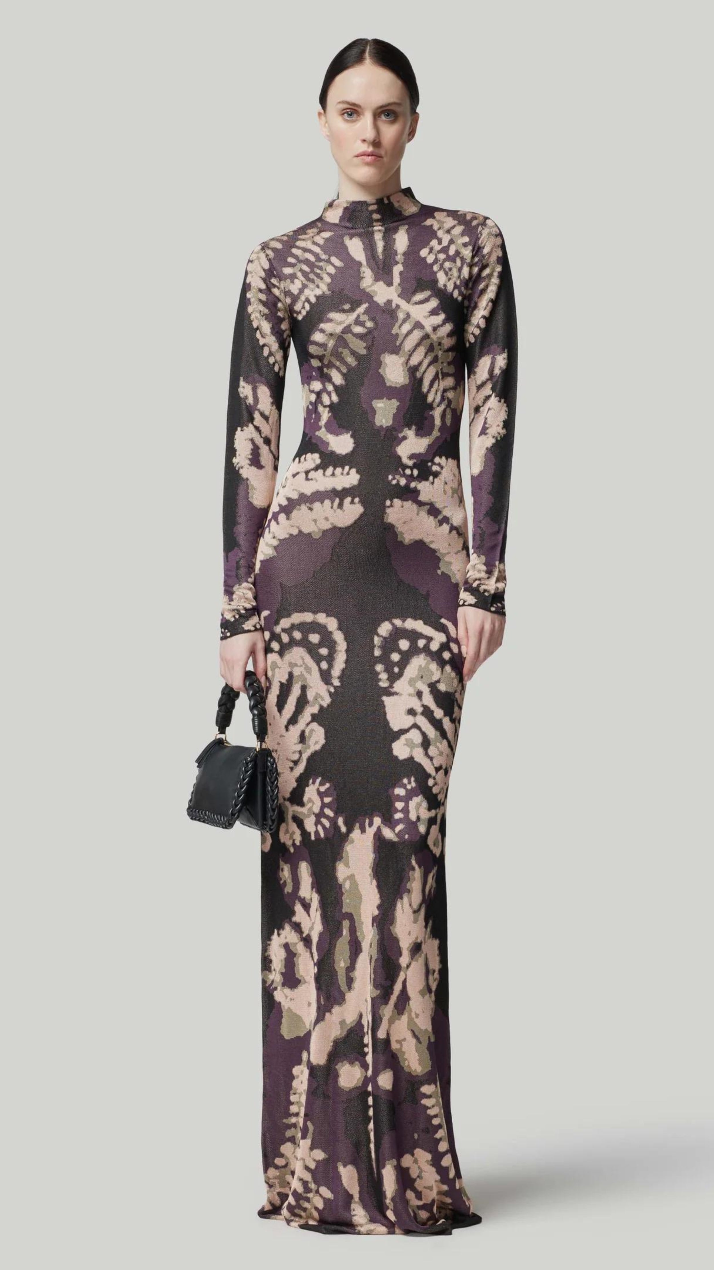 Altuzarra Rhea Dress. Knit dress in the rorschach in deep purple and pale pink. with a mock turtleneck, long sleeves and maxi length. Shown on model facing front