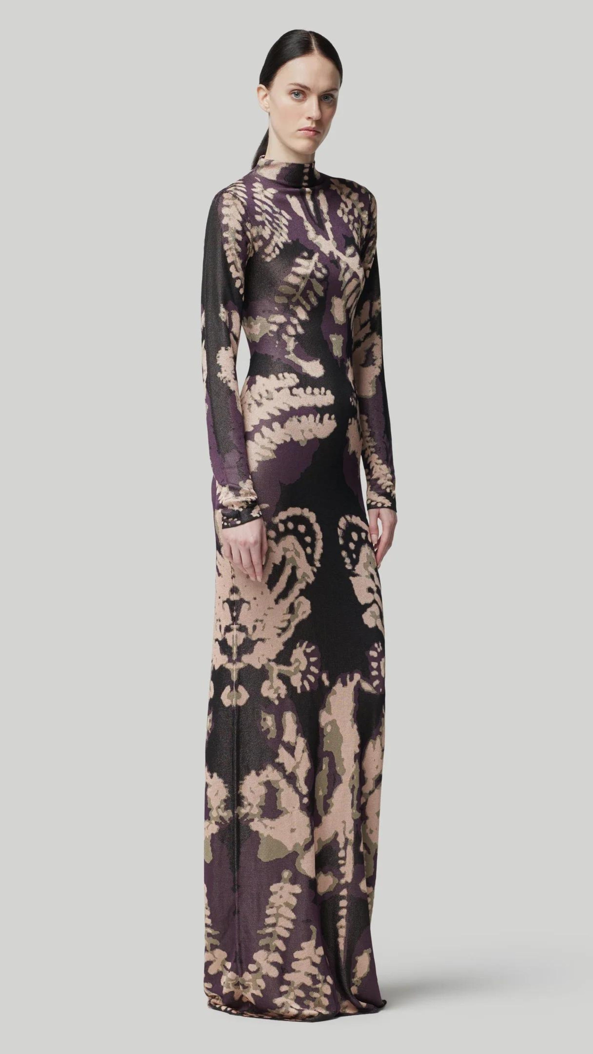 Altuzarra Rhea Dress. Knit dress in the rorschach in deep purple and pale pink. with a mock turtleneck, long sleeves and maxi length. Shown on model facing front